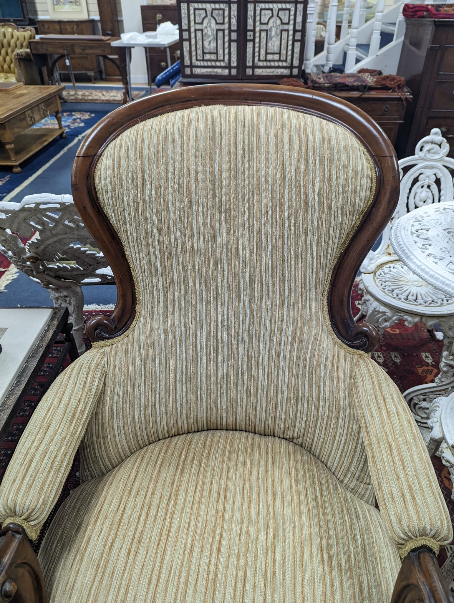 A Victorian upholstered spoon back armchair, width 71cm, depth 74cm, height 102cm